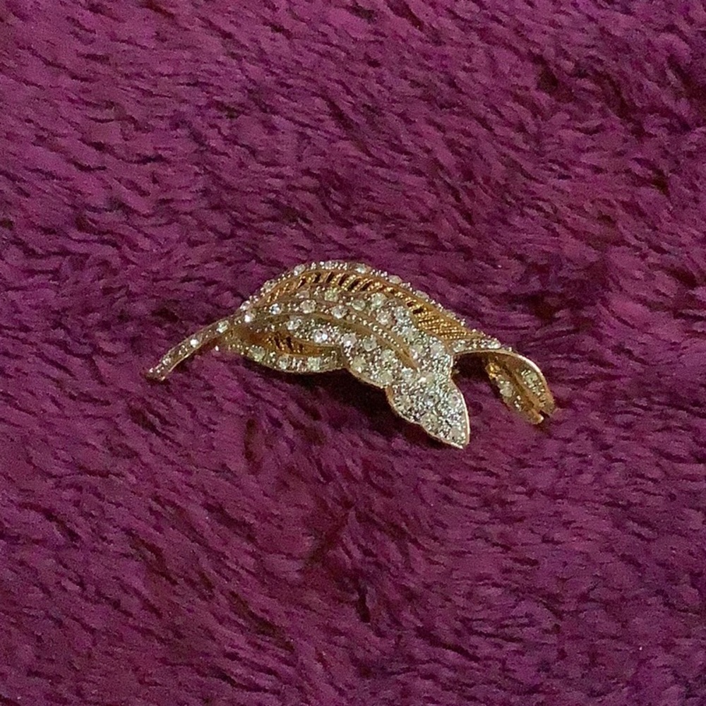 Goldtone and crystal rhinestone brooch